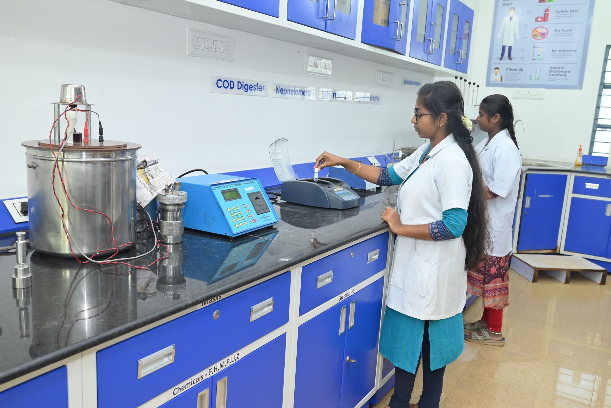 Analysts preparing samples at the COD digester bench