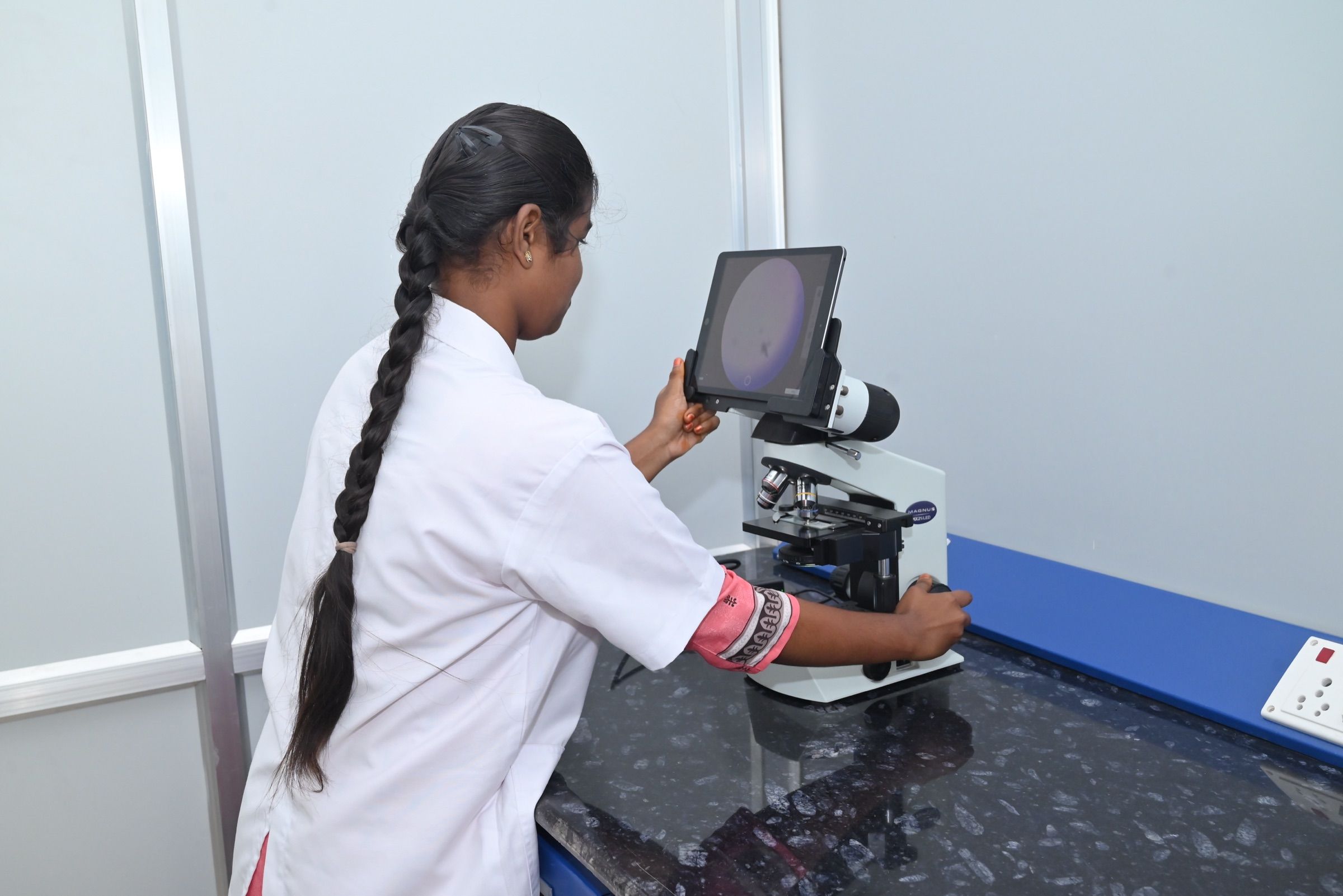 Analyst adjusting the digital microscope