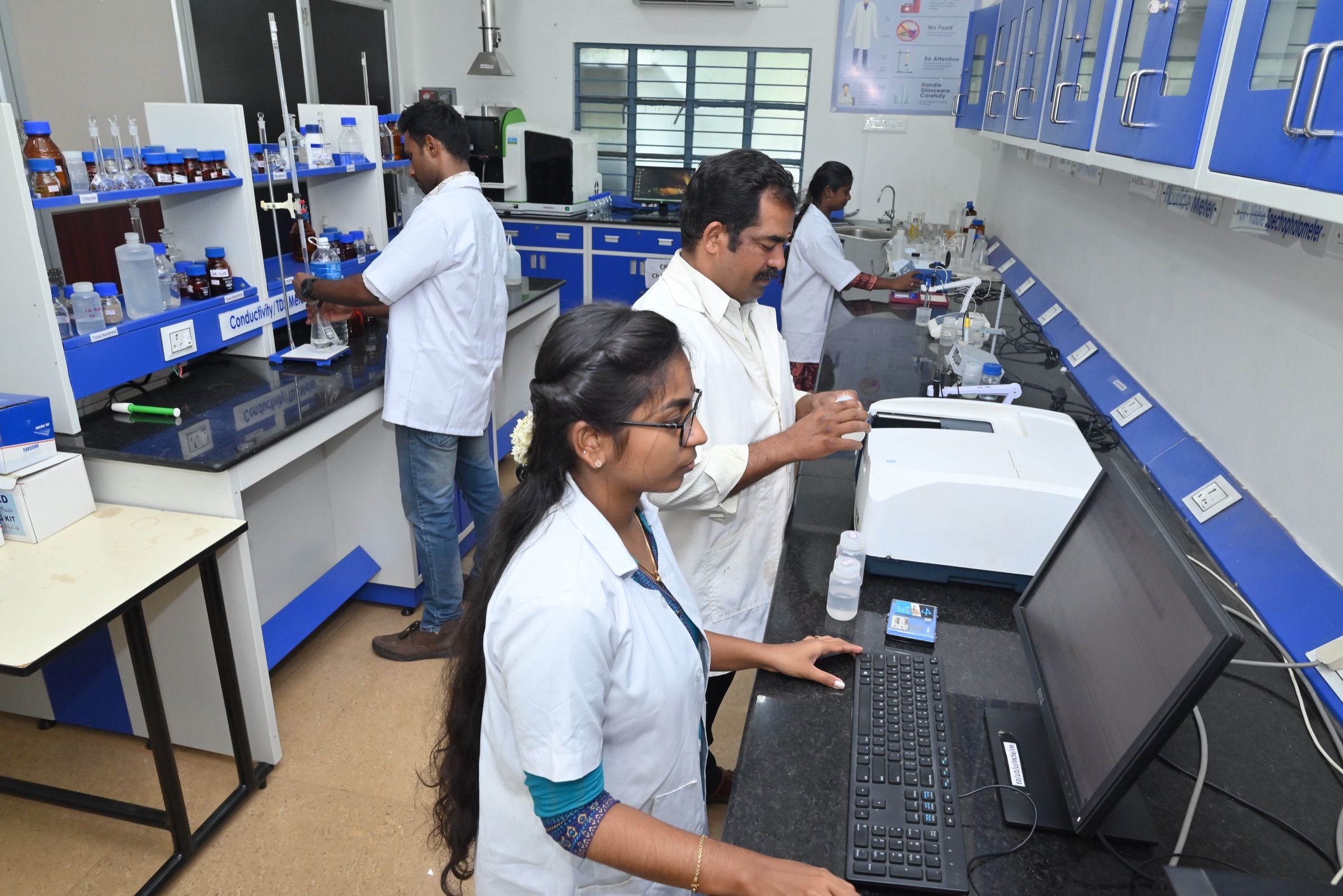 Laboratory team at the UV-Vis spectrophotometer and data workstation